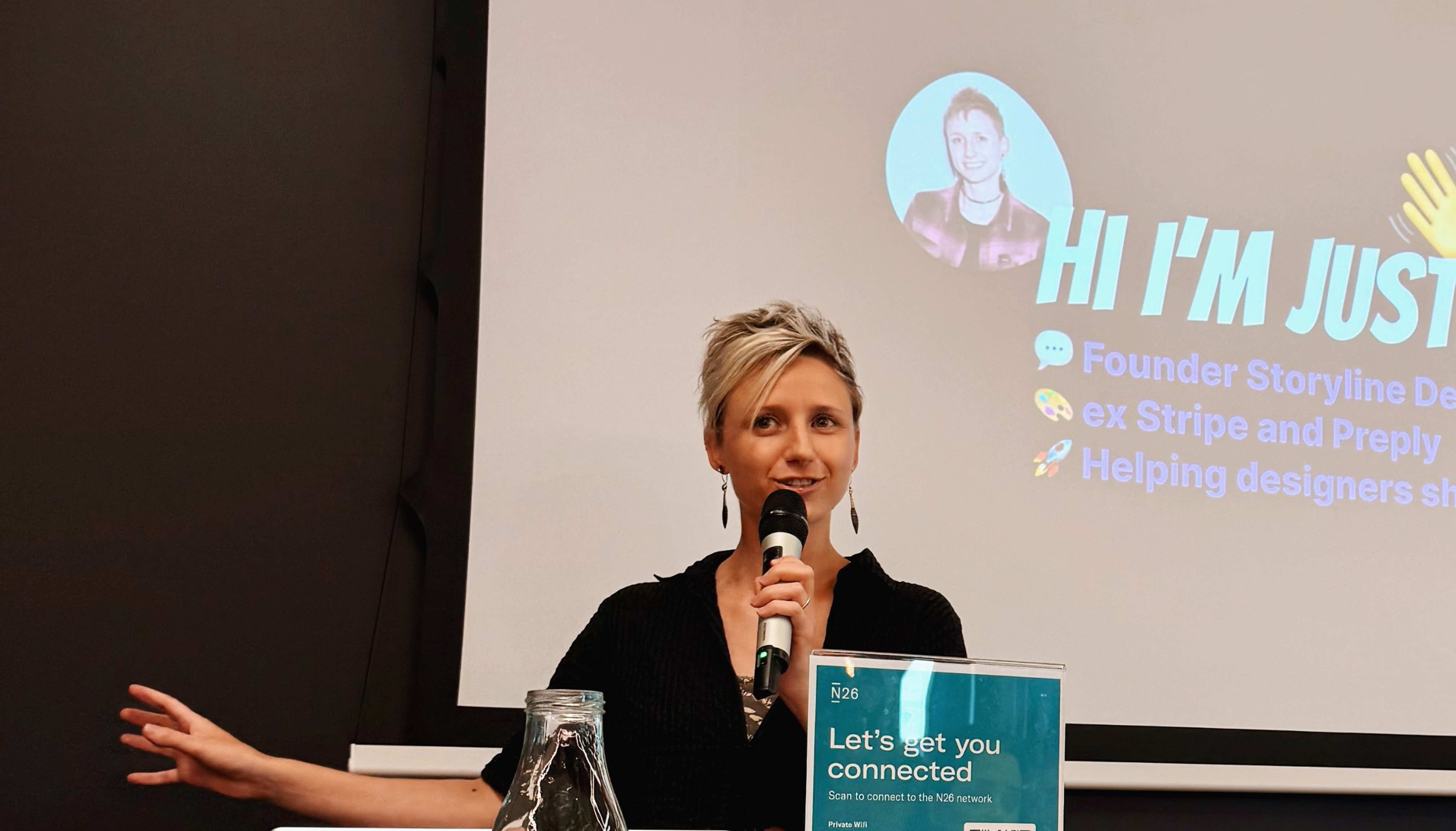 Justine speaking on stage